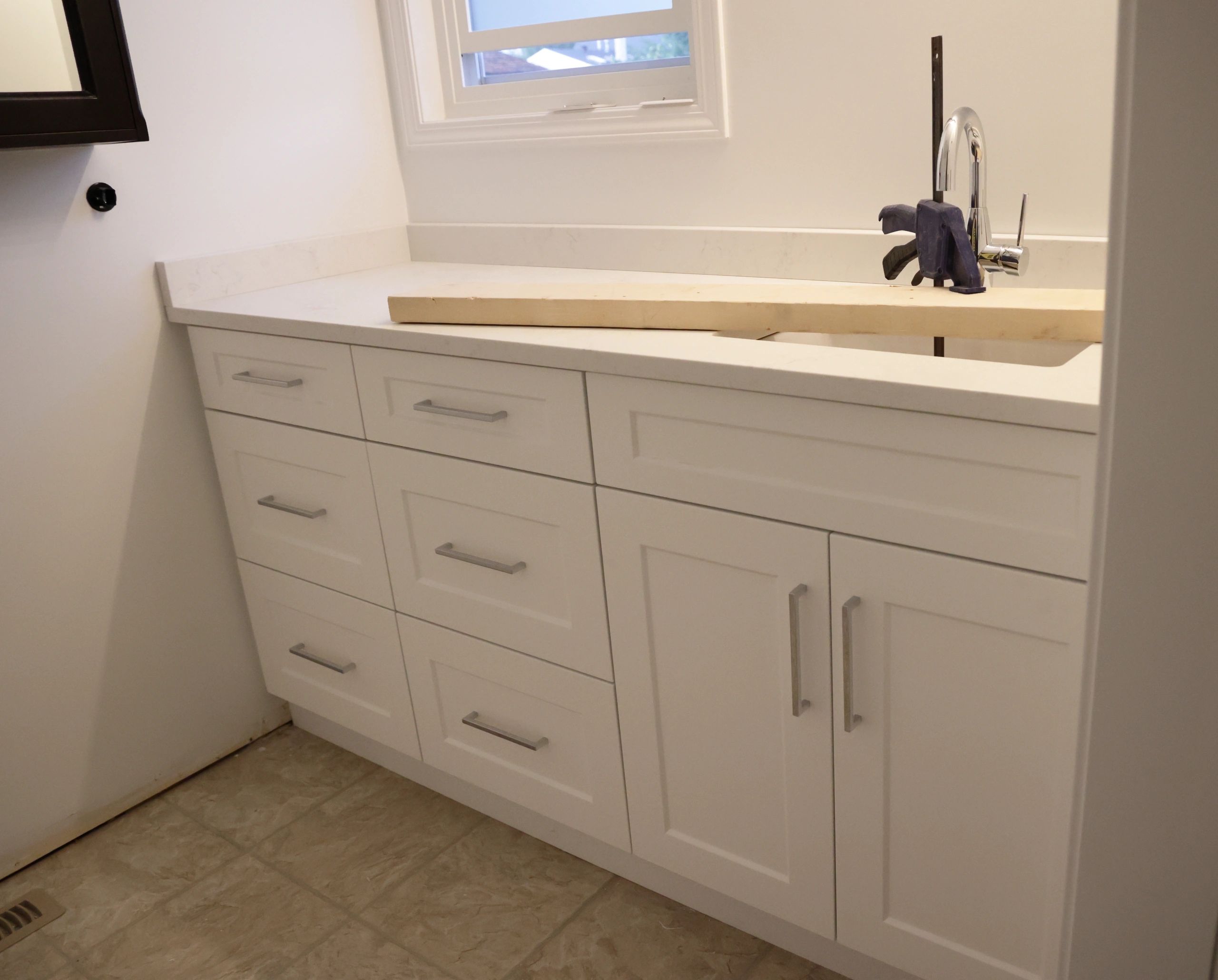 Custom vanity countertop and faucet installed during renovation