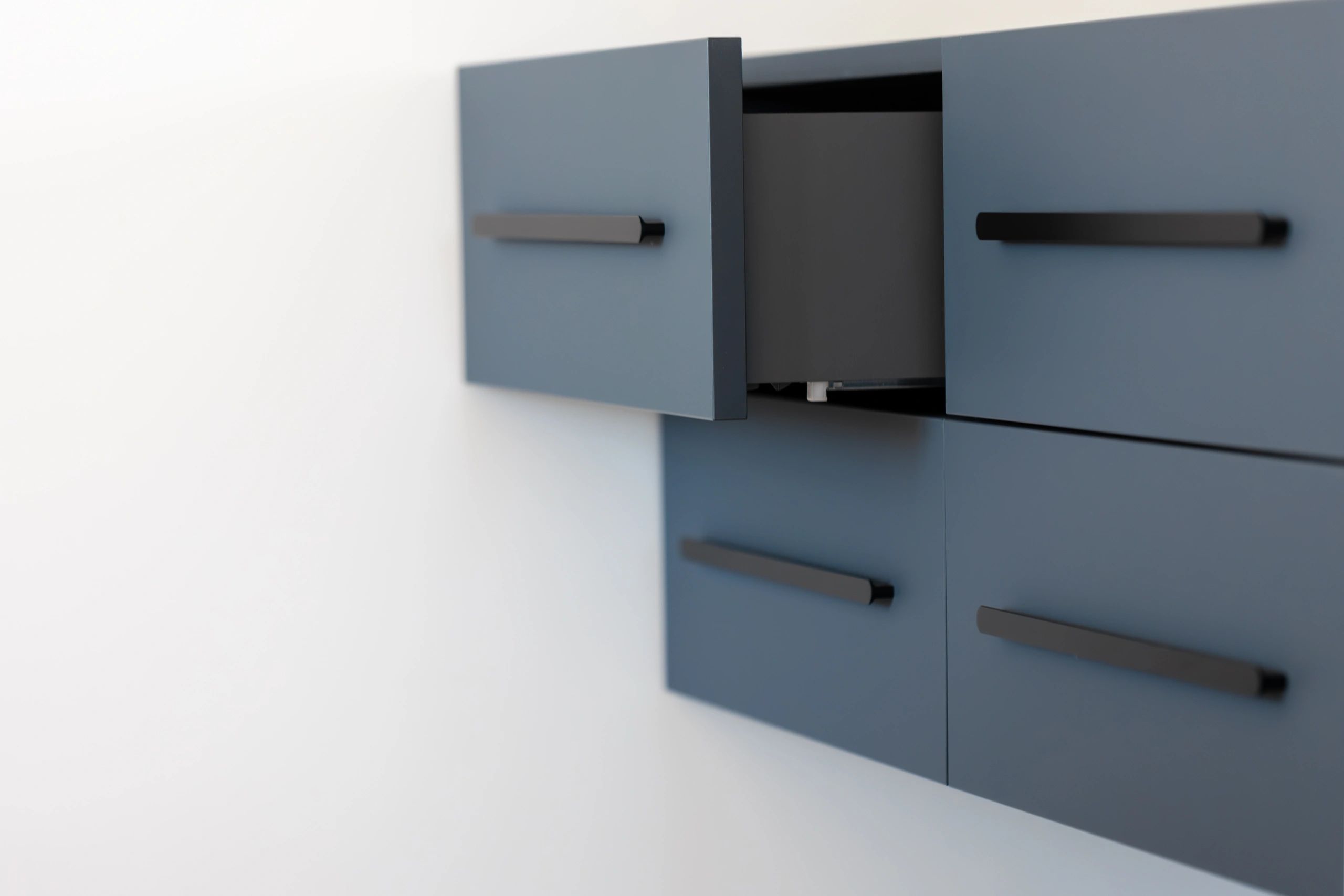 Wall-mounted cabinet with clean lines and black pulls