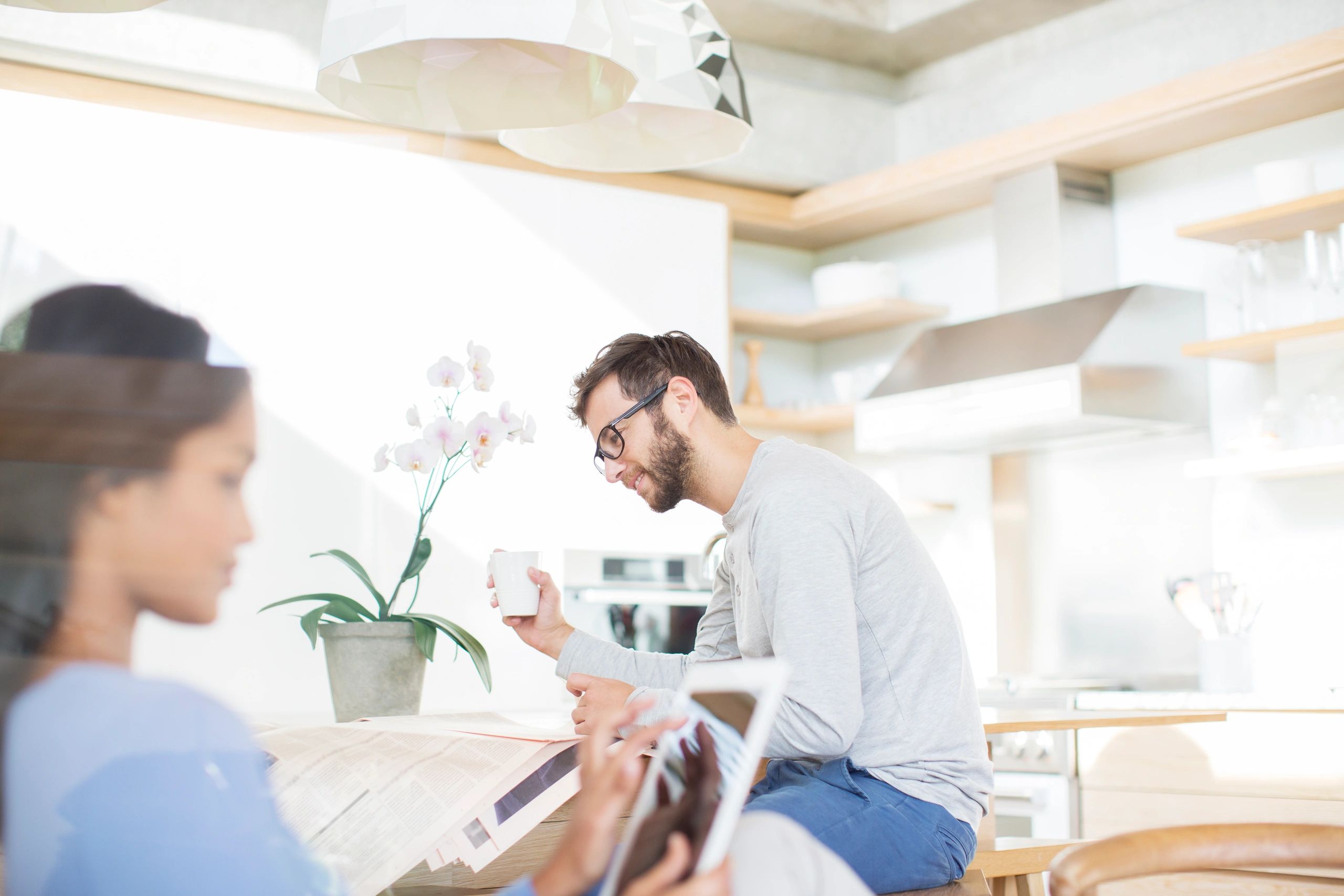Couple in a kitchen reviewing plans on a tablet